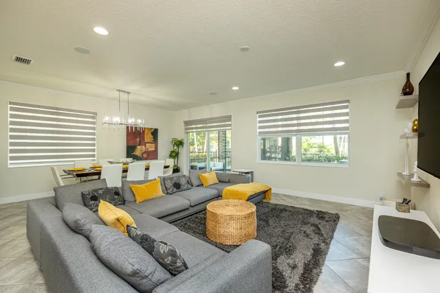 a spacious bathroom with a granite countertop sink a toilet and a mirror