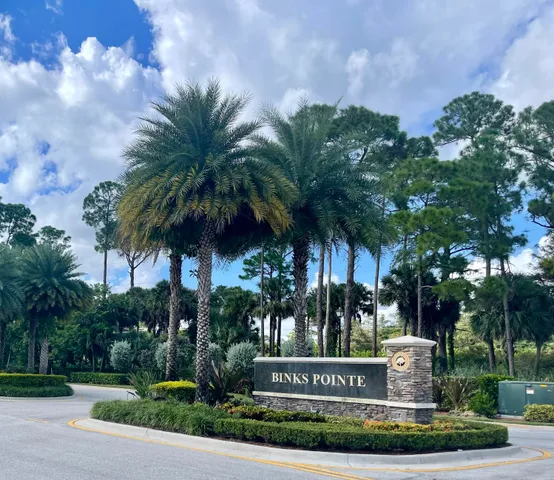 a view of a patio with a table and chairs and potted plants