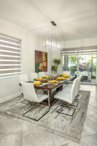 a bedroom with a bed a tv and wooden floor