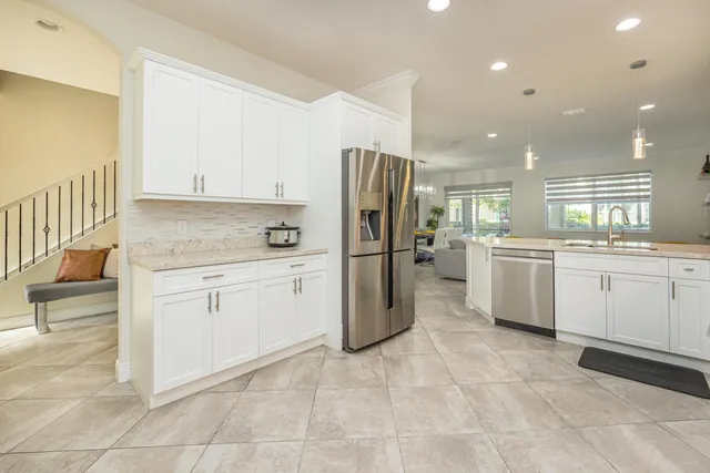 a bathroom with a granite countertop sink mirror and toilet