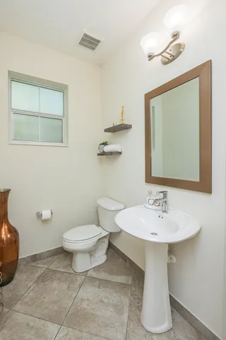 a bedroom with a bed a couch and a flat screen tv