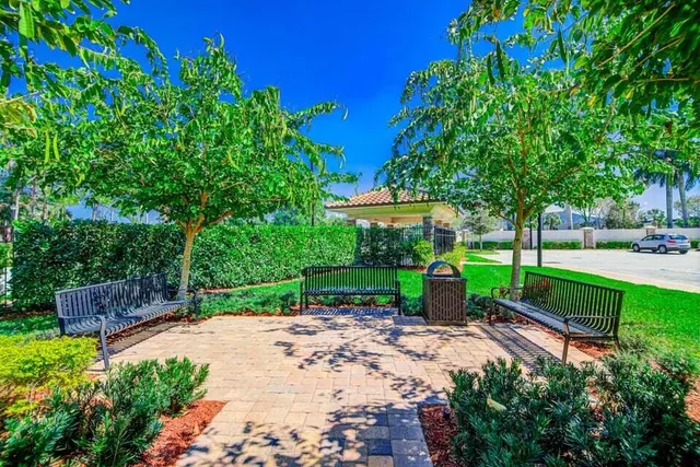 a view of swimming pool with outdoor seating and house in the background