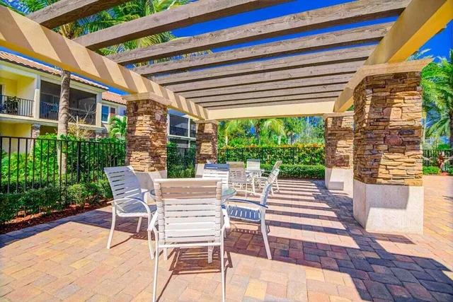 a front view of house with yard and trees in the background