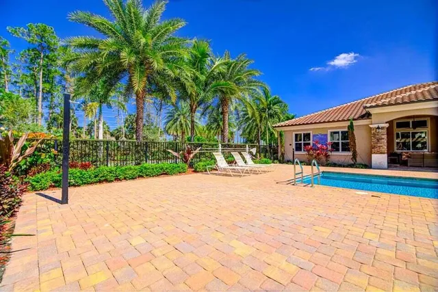 a view of a swimming pool with an outdoor space and seating area