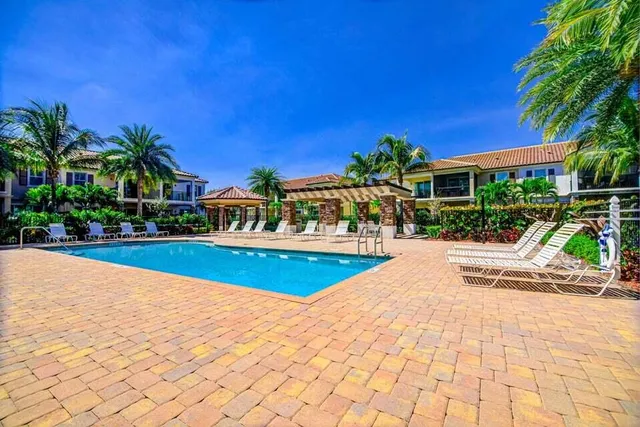 a view of a dining room with furniture and a chandelier
