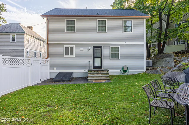 a front view of house with yard and outdoor seating