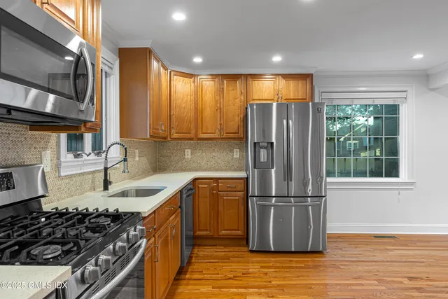 a kitchen with wooden cabinets and a stove top oven
