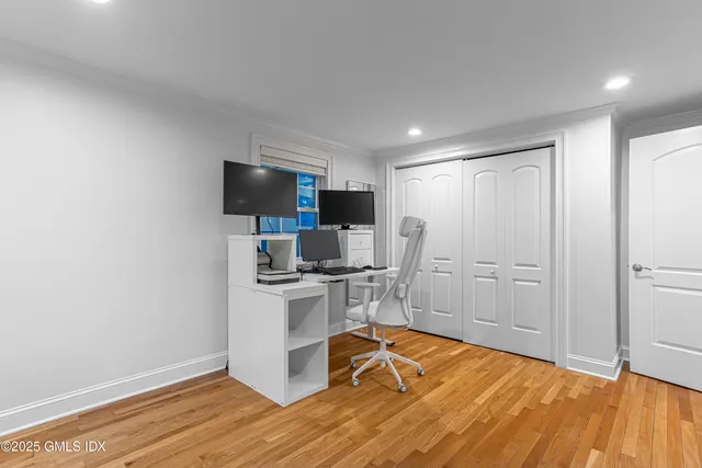 a room with wooden floor and white walls