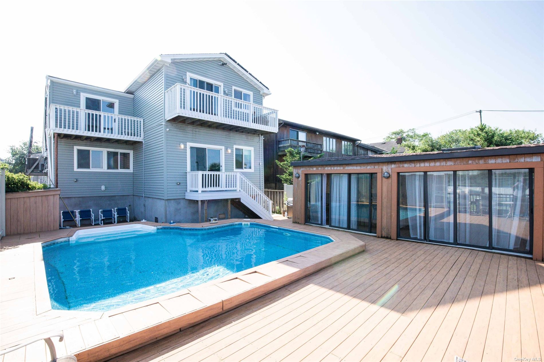 a view of a house with pool and wooden floor