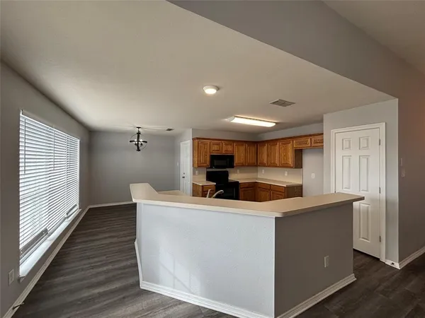 a view of a kitchen with sink and wooden floor