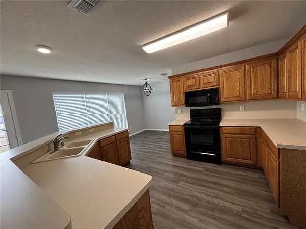 a kitchen that has a sink and a stove in it
