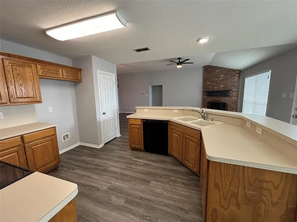 a spacious bathroom with a sink double vanity granite and a toilet
