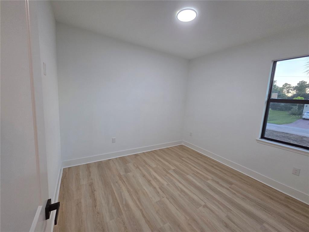 2967 Barry Road North Port, FL 34286 - Photo 14 of 16 a view of small space with wooden floor and fan