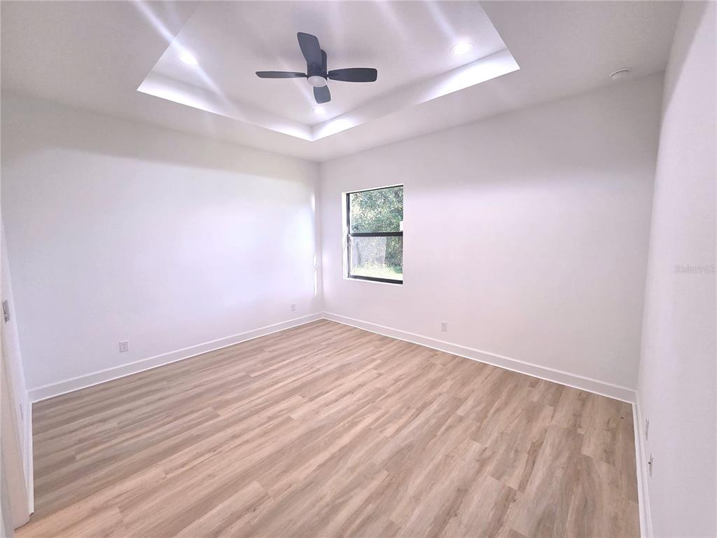 2967 Barry Road North Port, FL 34286 - Photo 8 of 16 wooden floor in an empty room