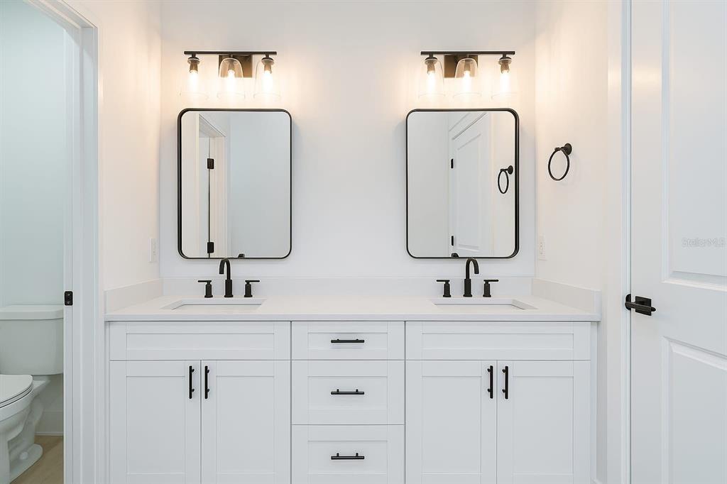 2967 Barry Road North Port, FL 34286 - Photo 9 of 16 a bathroom with double vanity sinks and a mirror