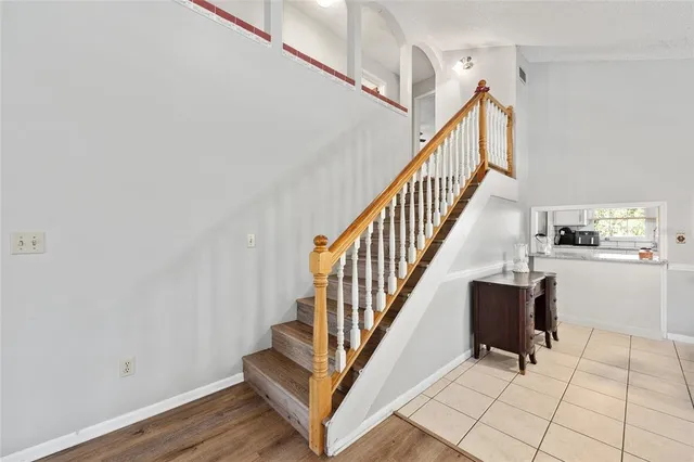 a view of entryway with wooden floor and stairs