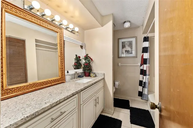a bathroom with a sink a mirror and a shower