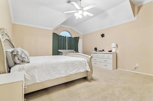 a bedroom with a bed and ceiling fan