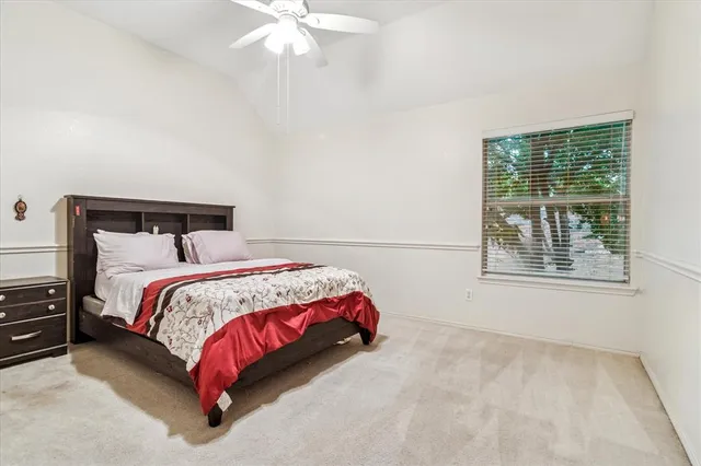 a bedroom with a bed and window