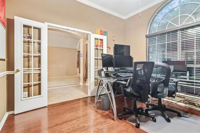 a view of a workspace with furniture and a window