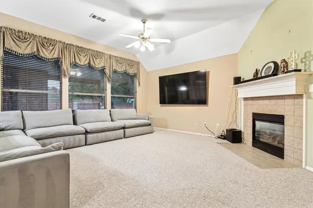 a living room with furniture a flat screen tv and a fireplace