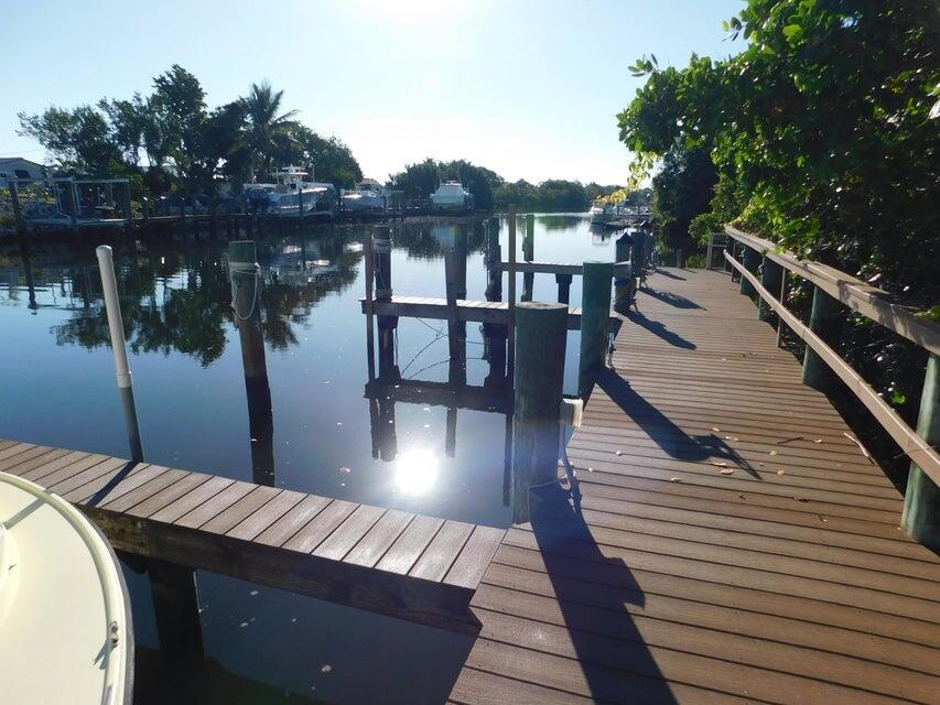 741 Hummingbird Way, Unit 8 North Palm Beach, FL 33408 - Photo 12 of 13 a view of balcony with wooden floor and lake view