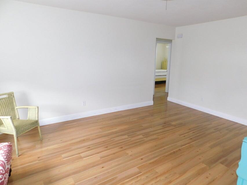 741 Hummingbird Way, Unit 8 North Palm Beach, FL 33408 - Photo 4 of 13 a view of an empty room and wooden floor