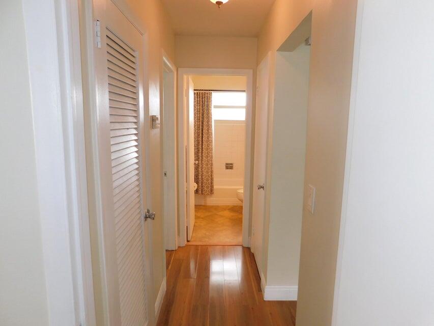 741 Hummingbird Way, Unit 8 North Palm Beach, FL 33408 - Photo 6 of 13 a view of a hallway with wooden floor and closet area