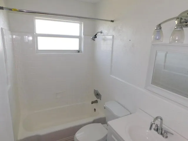 a bathroom with a shower and a sink