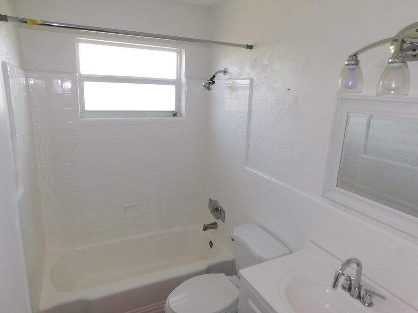 741 Hummingbird Way, Unit 8 North Palm Beach, FL 33408 - Photo 7 of 13 a bathroom with a shower and a sink