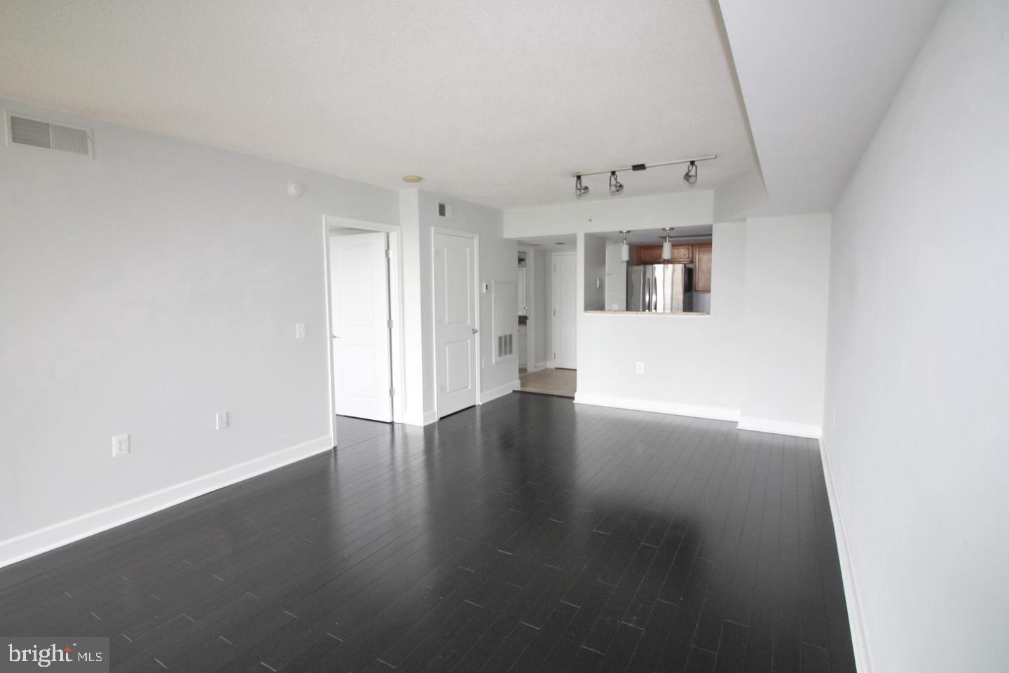 11800 Sunset Hills Road, Unit 625 Reston, VA 20190 - Photo 6 of 19 an empty room with wooden floor and windows