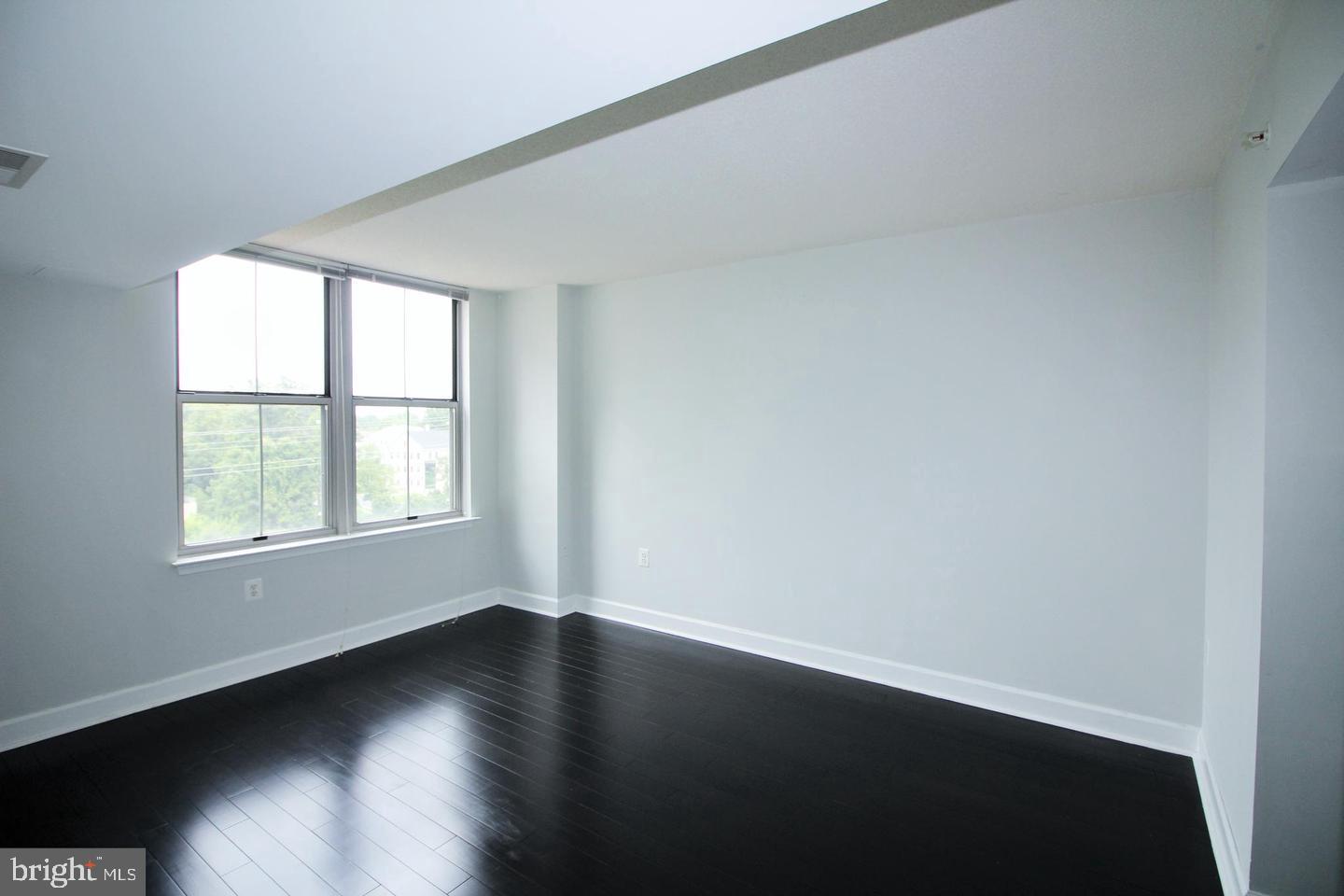 11800 Sunset Hills Road, Unit 625 Reston, VA 20190 - Photo 8 of 19 an empty room with wooden floor and windows