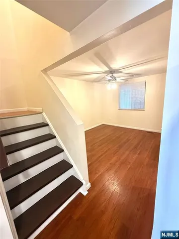 a view of a room with wooden floor and white walls