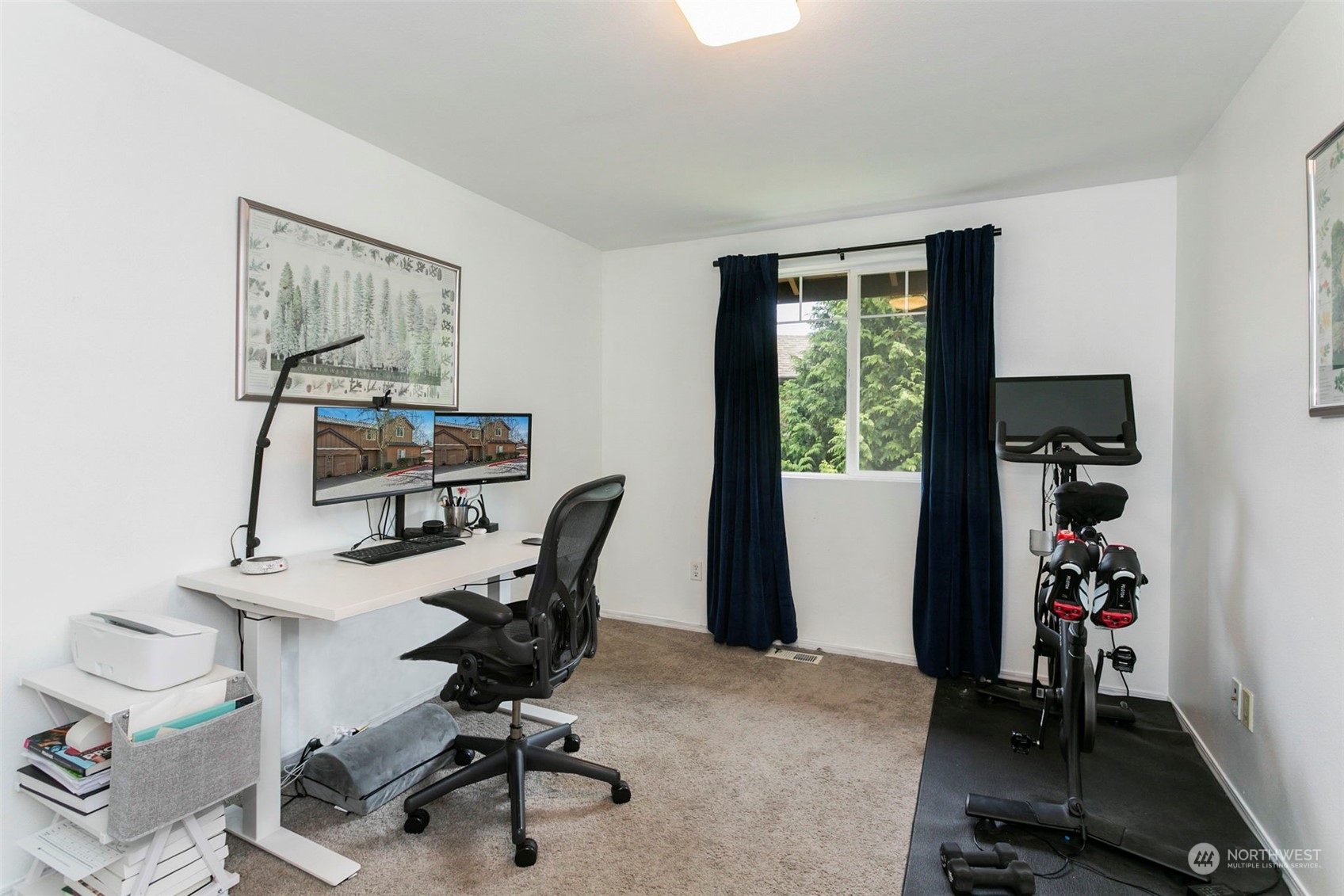 18930 Bothell Everett Highway, Unit J105 Bothell, WA 98012 - Photo 12 of 21 a view of a workspace with furniture and a window