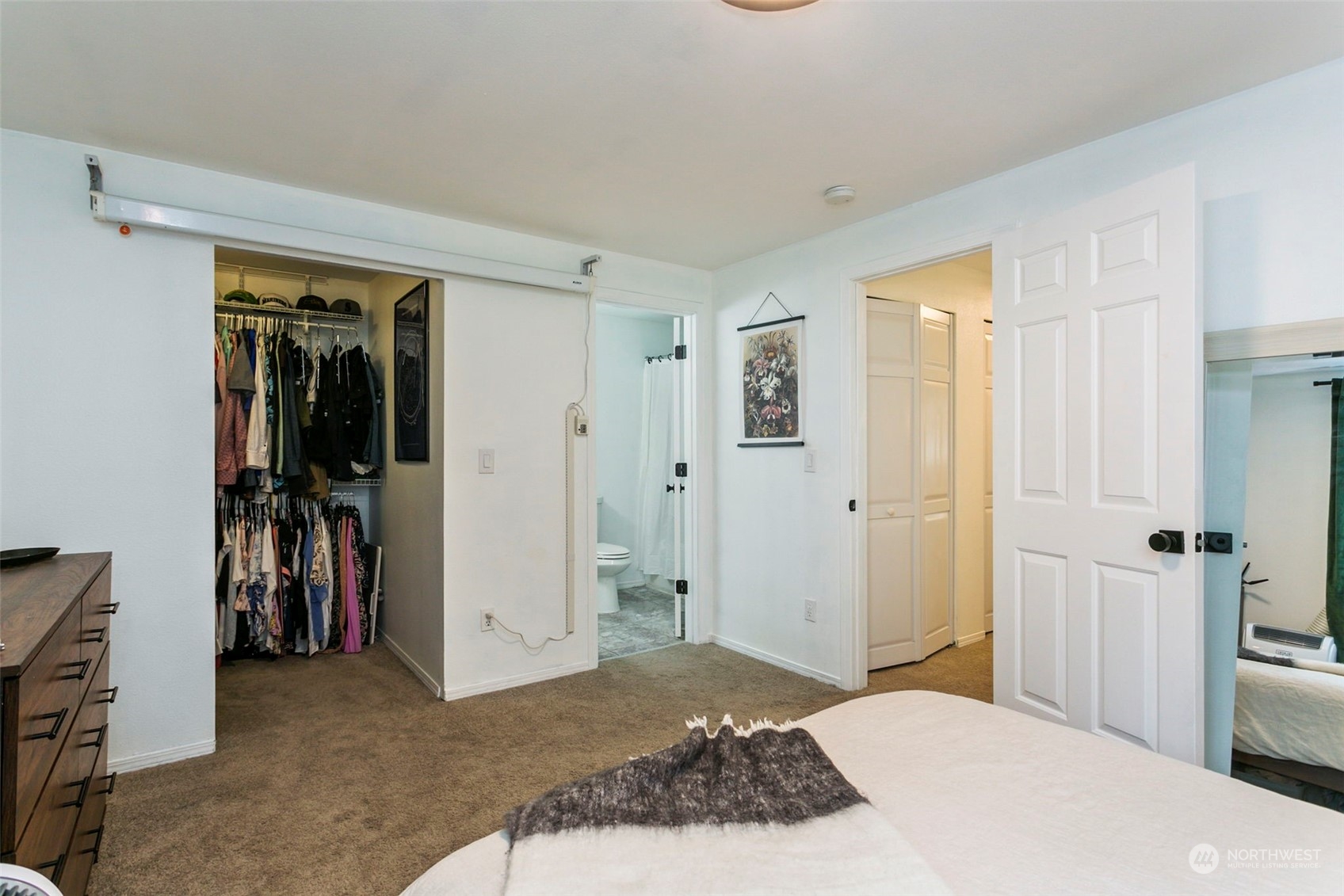 18930 Bothell Everett Highway, Unit J105 Bothell, WA 98012 - Photo 15 of 21 a bedroom with a bed and a mirror