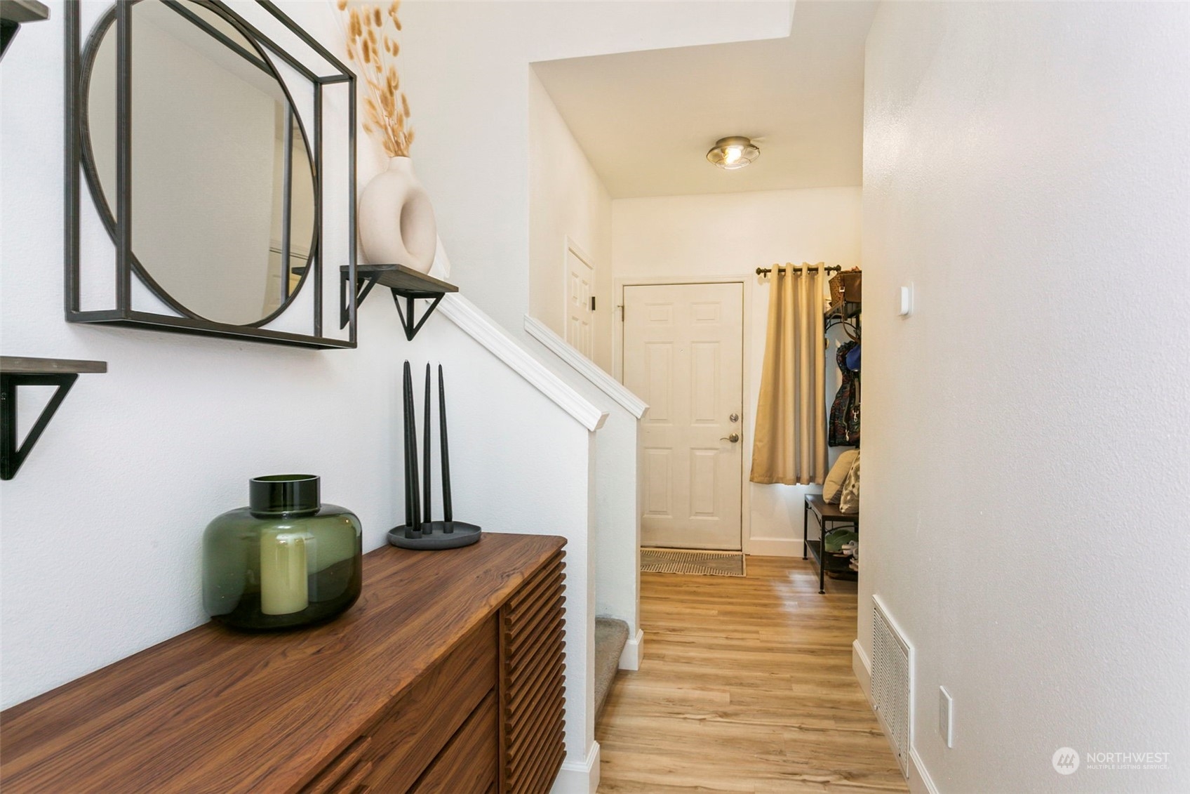 18930 Bothell Everett Highway, Unit J105 Bothell, WA 98012 - Photo 2 of 21 a view of a hallway with wooden floor and entryway