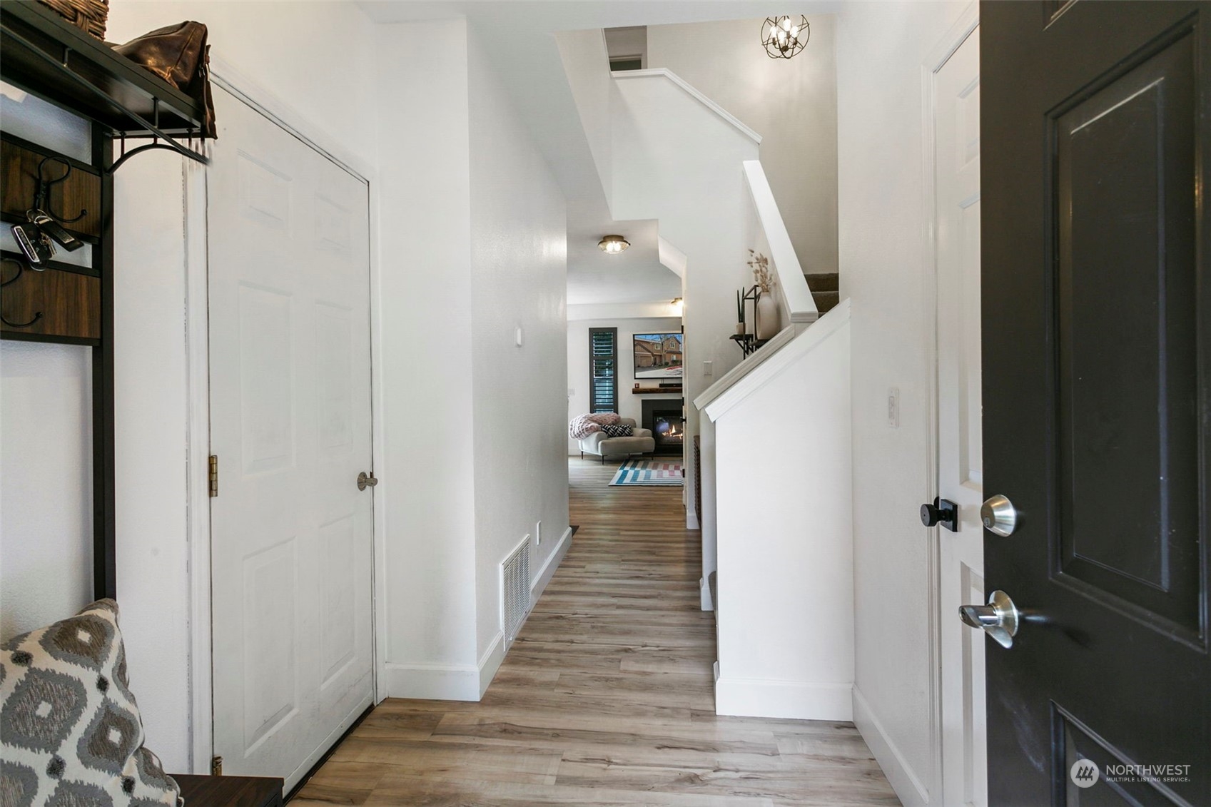18930 Bothell Everett Highway, Unit J105 Bothell, WA 98012 - Photo 3 of 21 a view of a hallway with wooden floor and staircase
