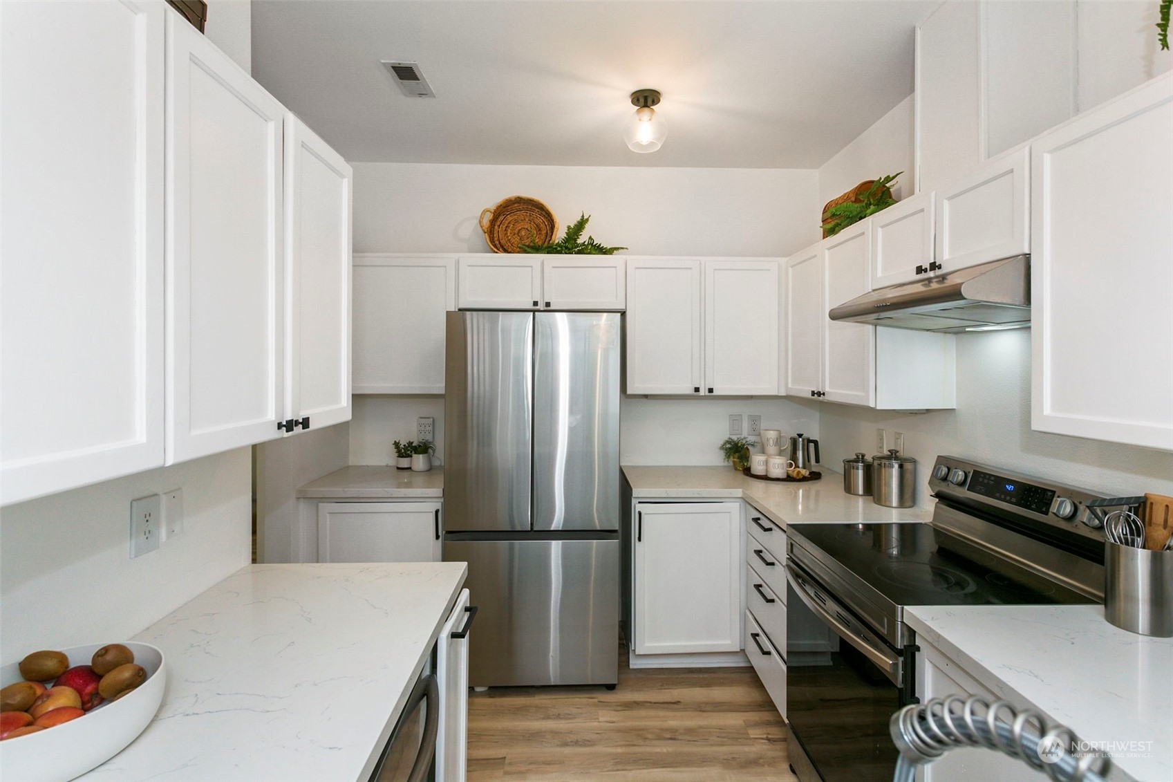 18930 Bothell Everett Highway, Unit J105 Bothell, WA 98012 - Photo 9 of 21 a kitchen with a refrigerator and a sink