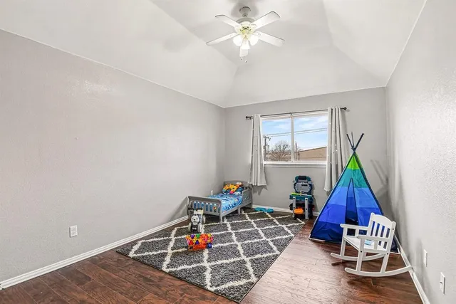 a bathroom with a granite countertop sink mirror vanity and toilet