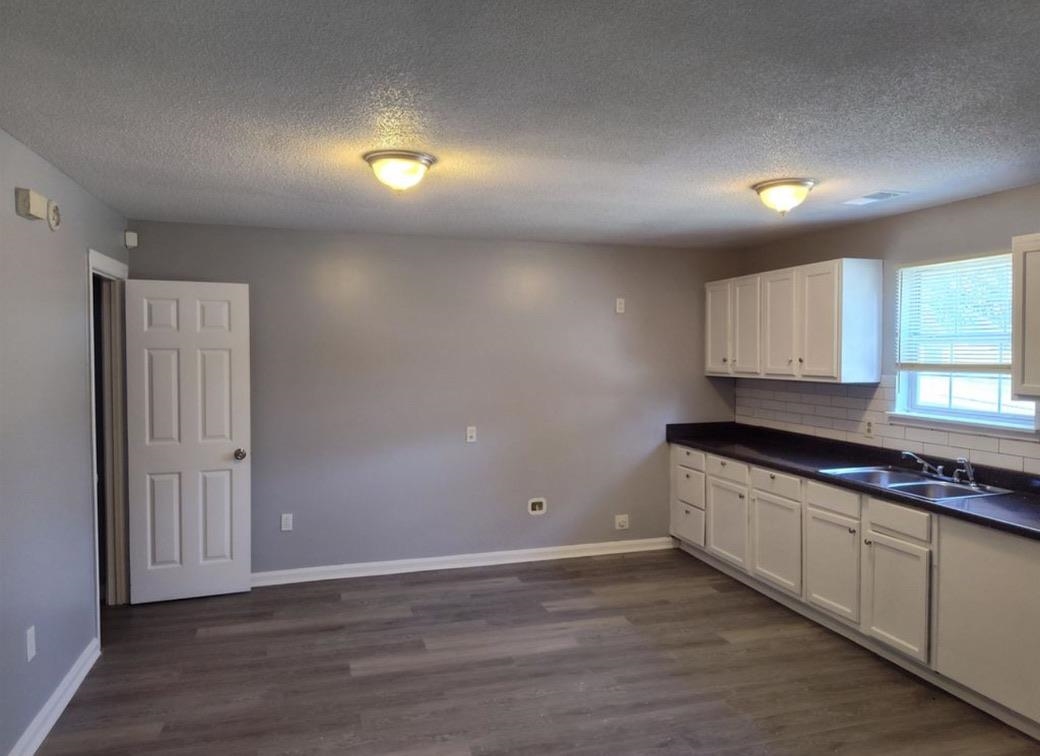 2525 Rozelle Street Memphis, TN 38114 - Photo 6 of 8 a kitchen with granite countertop a stove a sink and a microwave
