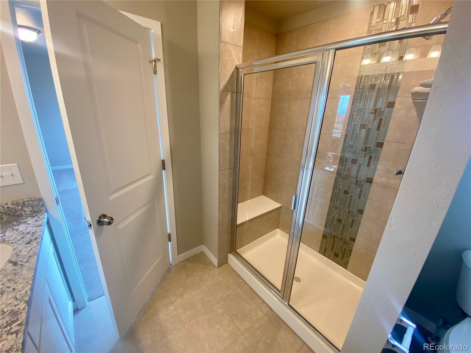 541 Ryan Avenue Fort Lupton, CO 80621 - Photo 17 of 29 a view of a bathroom with tub and door