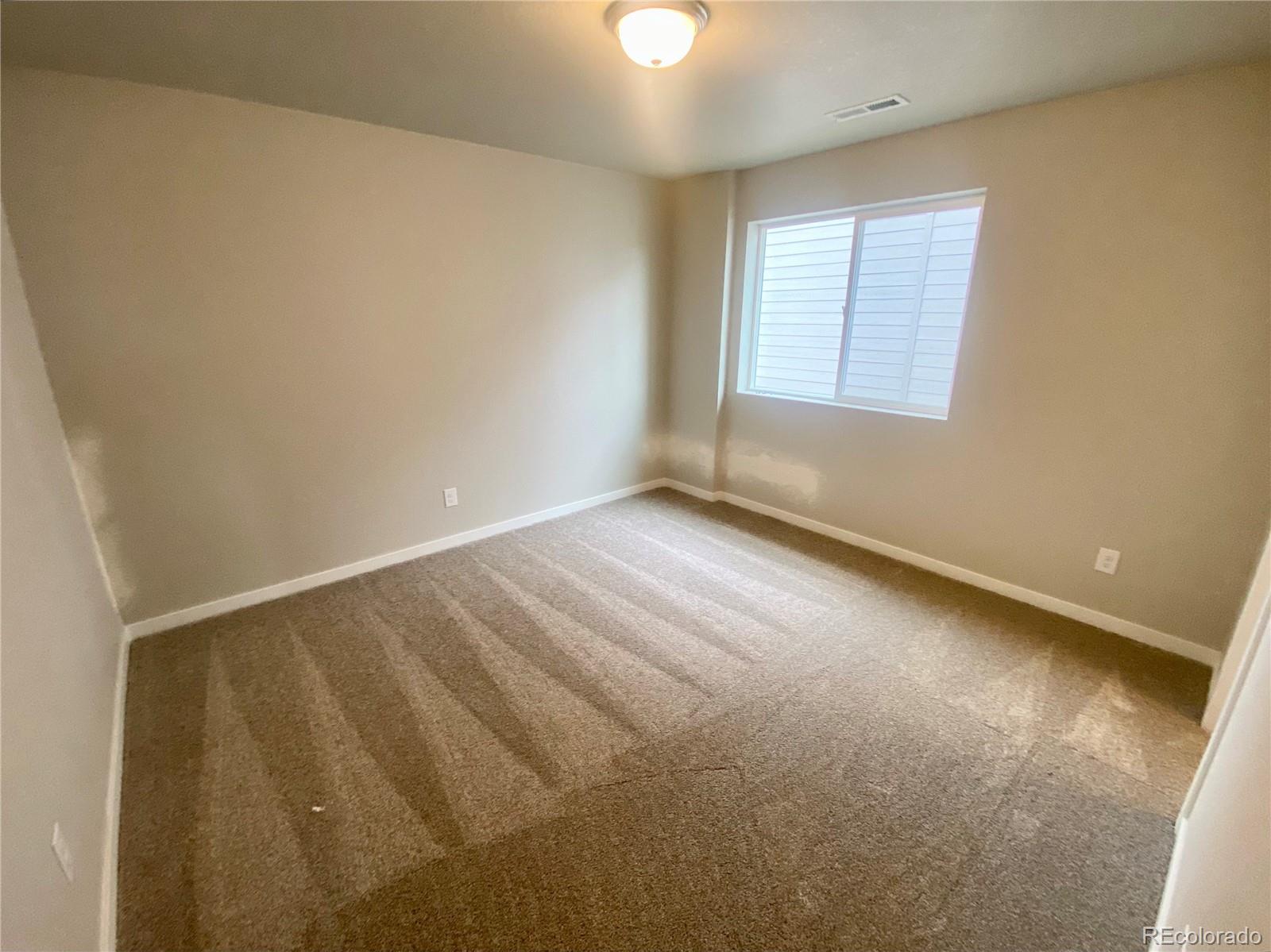 541 Ryan Avenue Fort Lupton, CO 80621 - Photo 23 of 29 an empty room with windows