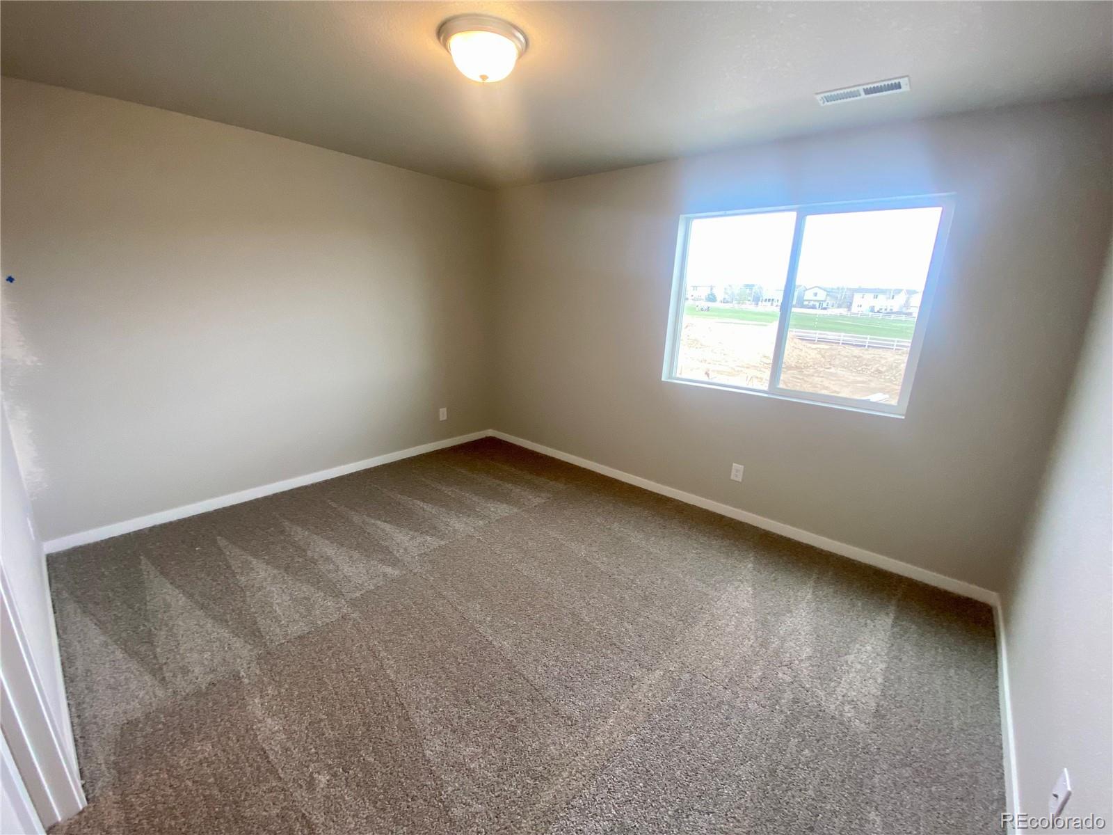 541 Ryan Avenue Fort Lupton, CO 80621 - Photo 25 of 29 an empty room with a window