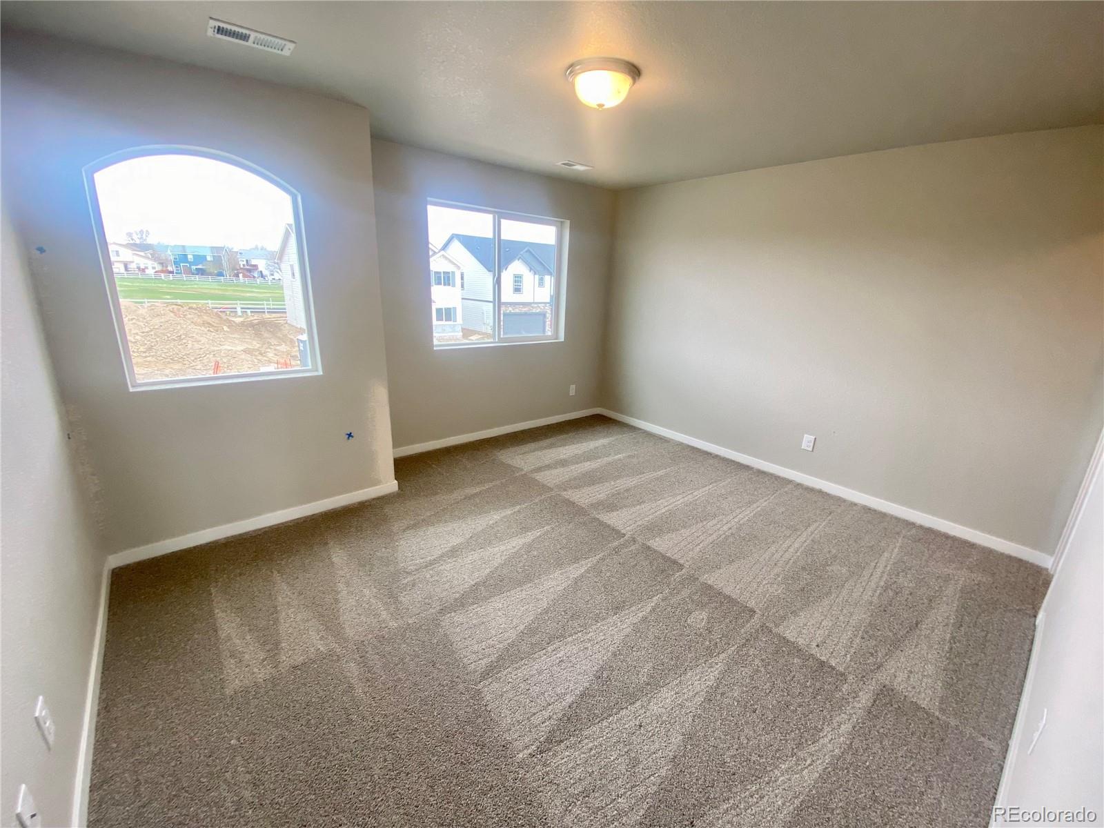 541 Ryan Avenue Fort Lupton, CO 80621 - Photo 28 of 29 an empty room with windows