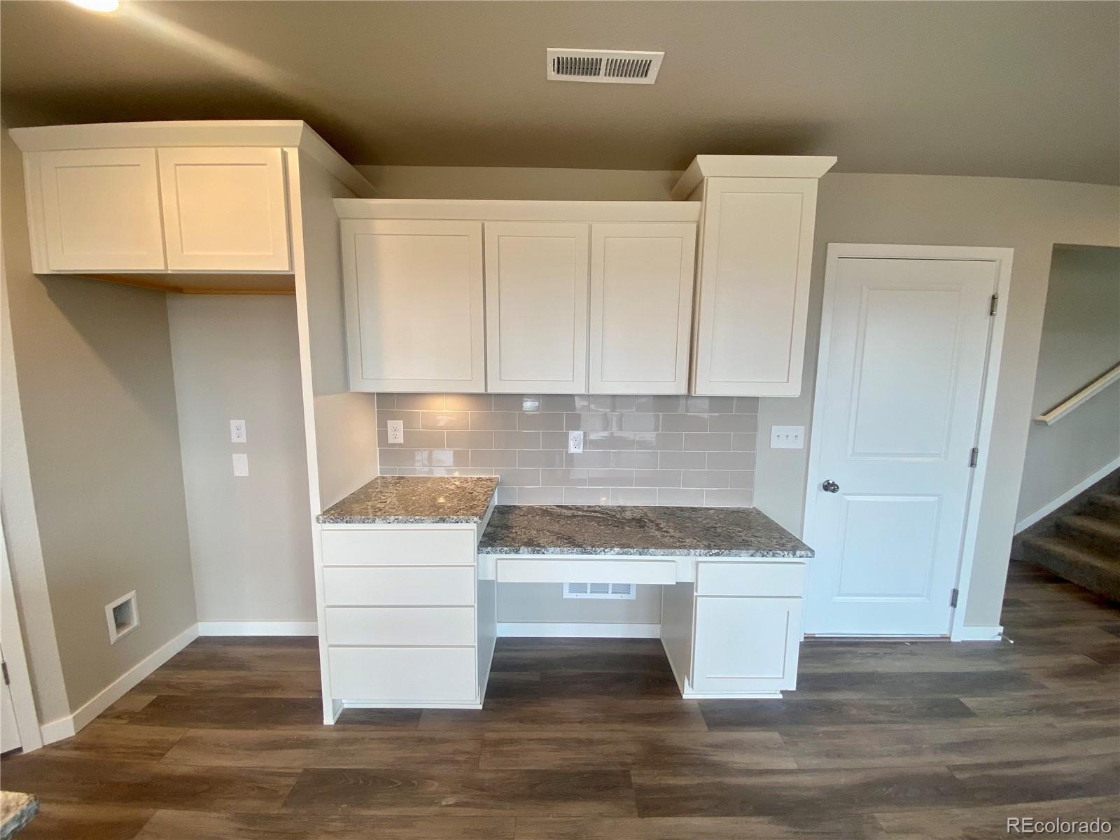541 Ryan Avenue Fort Lupton, CO 80621 - Photo 7 of 29 a kitchen with a cabinets and wooden floor