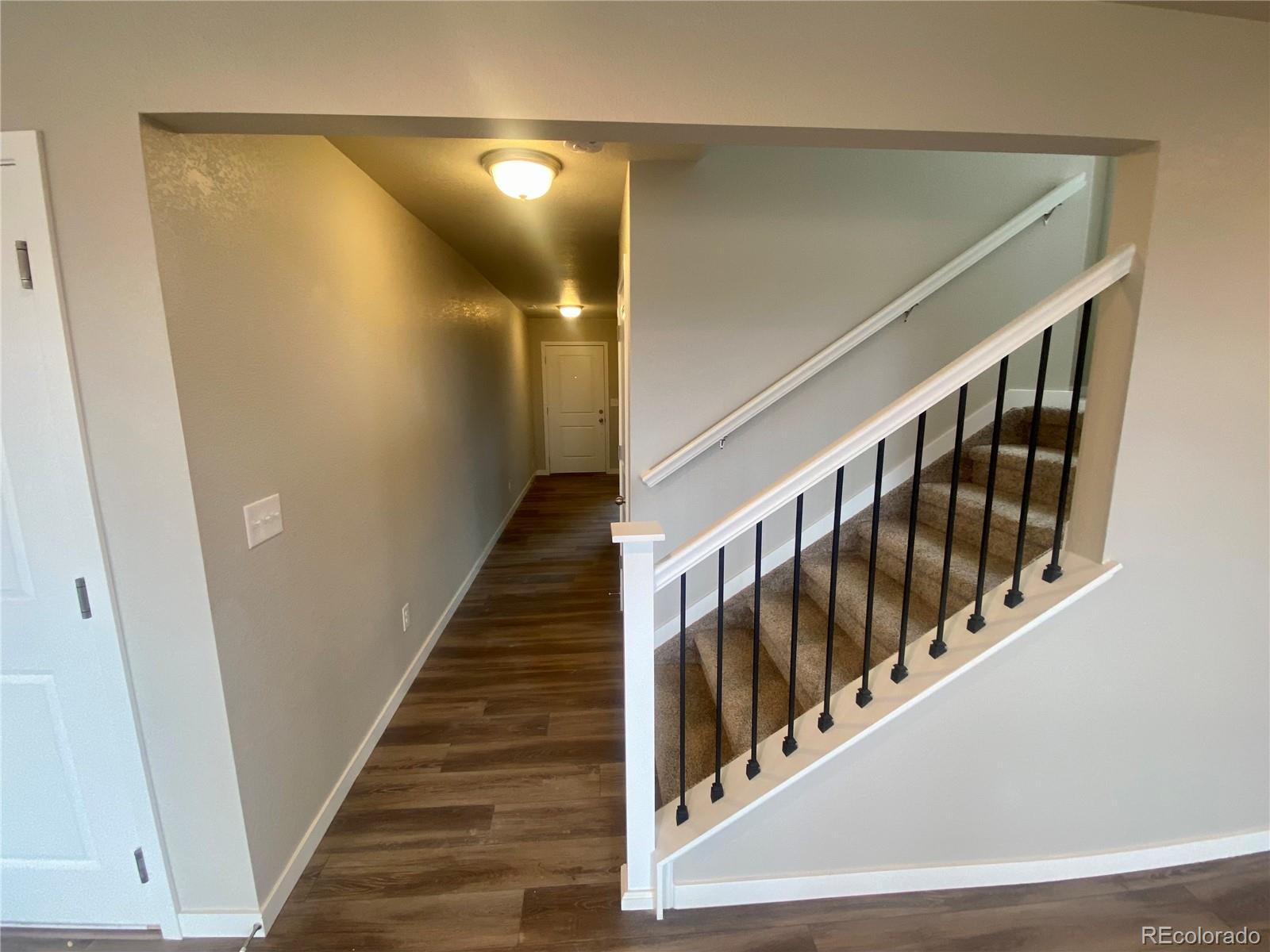 541 Ryan Avenue Fort Lupton, CO 80621 - Photo 10 of 29 a view of staircase with railing and white walls