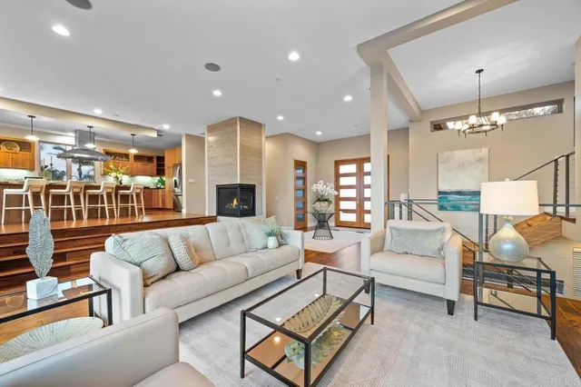 a living room with furniture and a chandelier