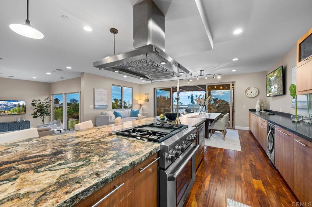 614 Ocean View Avenue Encinitas, CA 92024 - Photo 15 of 40 a kitchen with stainless steel appliances granite countertop a stove a sink dishwasher a refrigerator and white cabinets with wooden floor