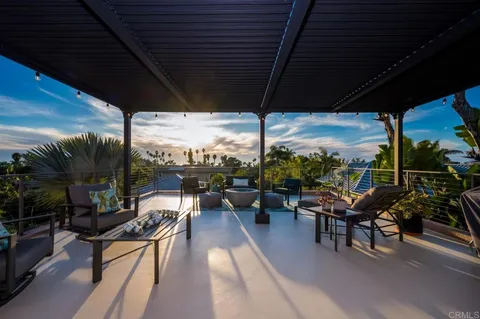 a view of a patio with table and chairs and potted plants