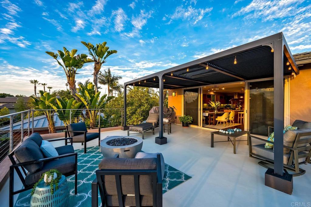 614 Ocean View Avenue Encinitas, CA 92024 - Photo 19 of 40 a view of a patio with table and chairs and potted plants